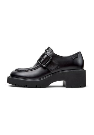 Black leather shoes with a buckle detail, rounded toe, and chunky platform sole. Smooth texture and stitching accents along the upper.