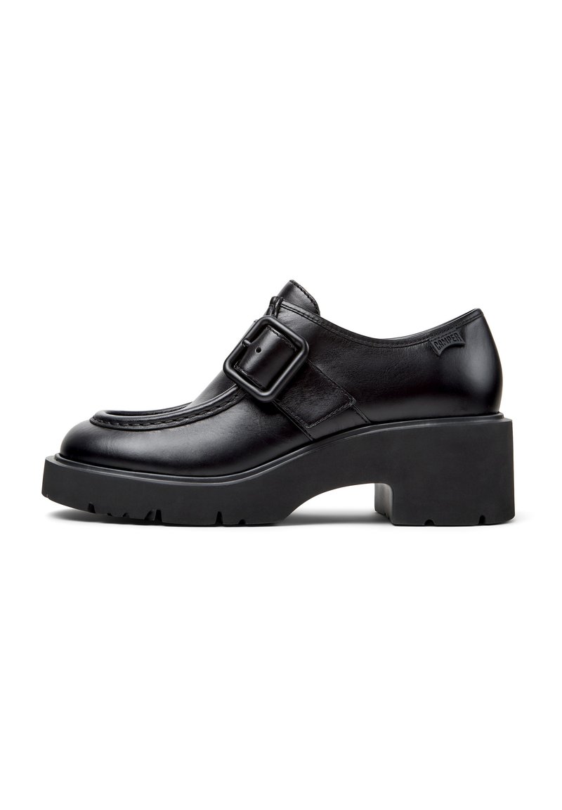 Black leather shoes with a buckle detail, rounded toe, and chunky platform sole. Smooth texture and stitching accents along the upper.