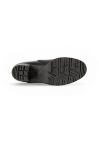 Semelle noire d'une chaussure Gabor avec des motifs de grip texturés, montrant un design anti-glisse au niveau du talon et des orteils sur un fond blanc.
