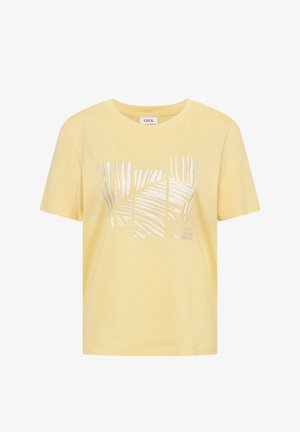 Gele korte mouwen t-shirt met zilveren palmbladprint en kleine tekst "Build Confidence" aan de voorkant, ronde halslijn.