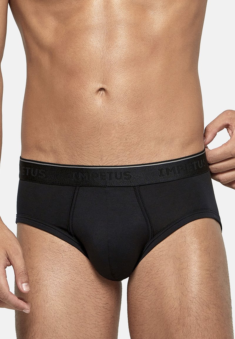 Black cotton brief with a smooth texture, elastic waistband featuring the brand name "IMPETUS," and a fitted design that contours to the body.