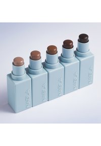Four NABLA cream stick products in light blue rectangular packaging, featuring varying shades of brown pigments on top.