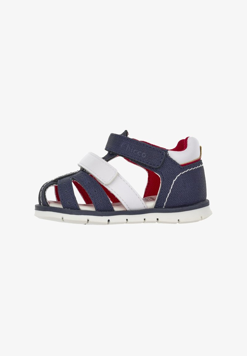 Sandale pour enfants bleu et blanc avec des sangles Velcro, design ouvert, dessus texturé, doublure rouge et semelle en caoutchouc blanc.