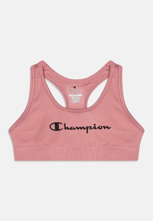 Rožinė sportinė liemenėlė su lygiu paviršiumi, sportiniu nugaros dizainu ir išryškinta juoda "Champion" logotipu priekyje.