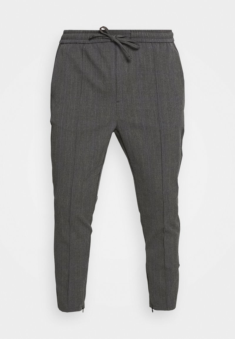 Pantalon slim gris foncé avec motif à carreaux discret, taille élastique, cordon de serrage et fermetures éclair aux chevilles mettant en valeur une coupe ajustée.