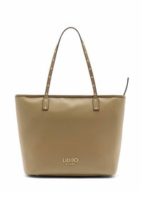 Bézs bőrből készült válltáska k�ét vállpánttal, szegecses díszítéssel és dombornyomott logóval az elején. Simák a felülete, téglalap alakú.