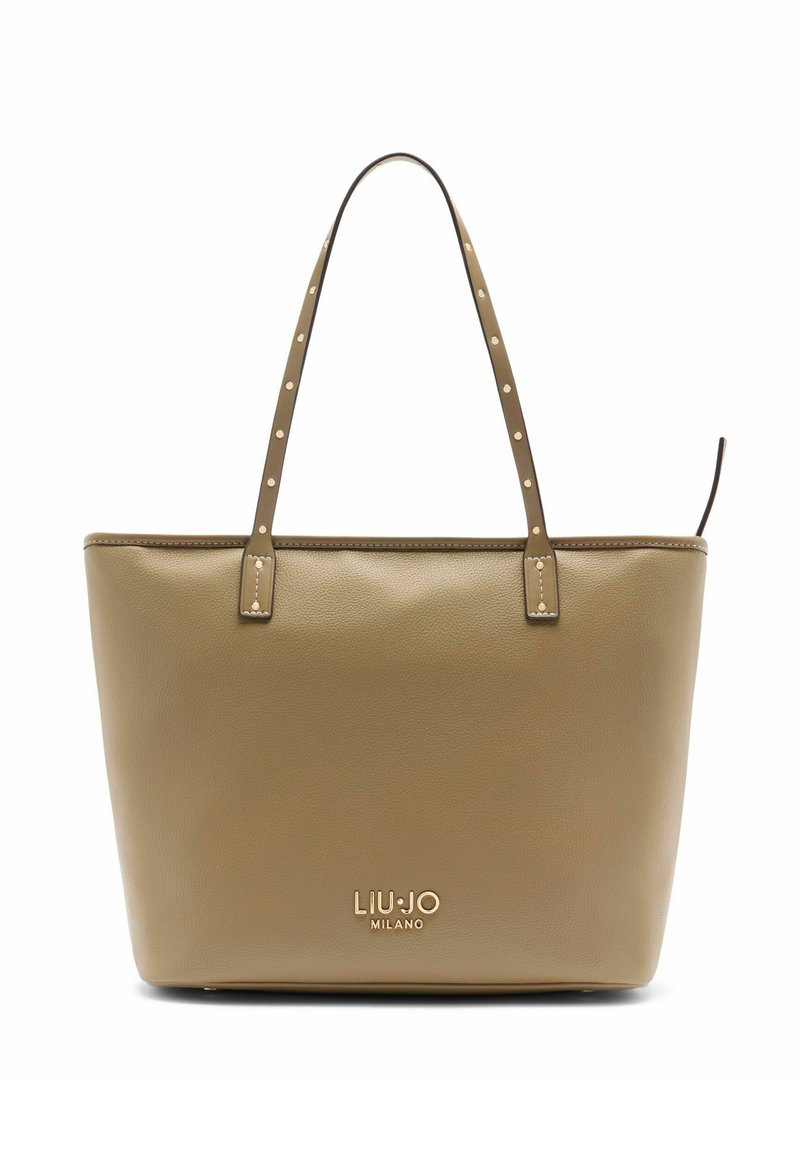 Bézs bőrből készült válltáska két vállpánttal, szegecses díszítéssel és dombornyomott logóval az elején. Simák a felülete, téglalap alakú.