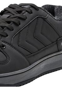 Czarne trampki z teksturowaną gumową podeszwą, wzorem w zygzak po boku, okrągłym noskiem i płaskimi sznurowadłami. Gładka syntetyczna cholewka z delikatnymi detalami przeszycia.