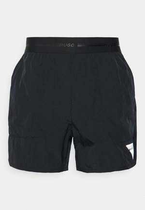 Sorte herre badeshorts med elastisk talje med "Hugo" branding og et lille logodetalje på den nederste side.