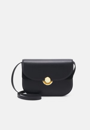 Black leather handbag with smooth texture, flap closure, and a round gold hardware accent. Includes a detachable shoulder strap.