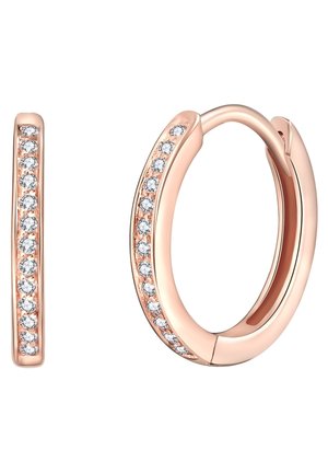 Boucles d'oreilles créoles en or rose avec une rangée de petites pierres précieuses rondes et transparentes le long du bord extérieur, fermeture simple visible sur une boucle d'oreille.