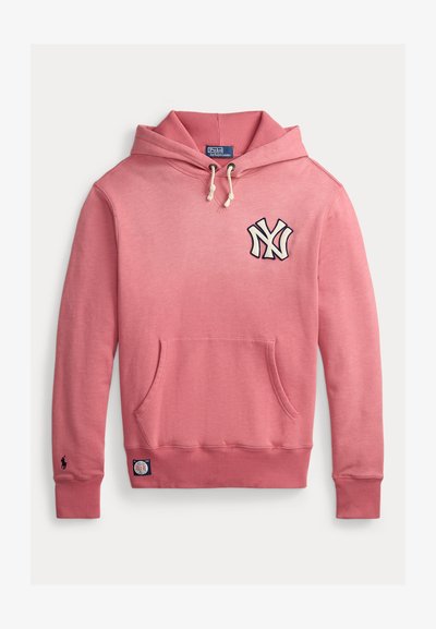 Sudadera con capucha de color rosa claro con un bolsillo tipo canguro, puños acanalados y una etiqueta tejida. Presenta un logo de NY en color azul marino en el pecho. Tela de mezcla de algodón.