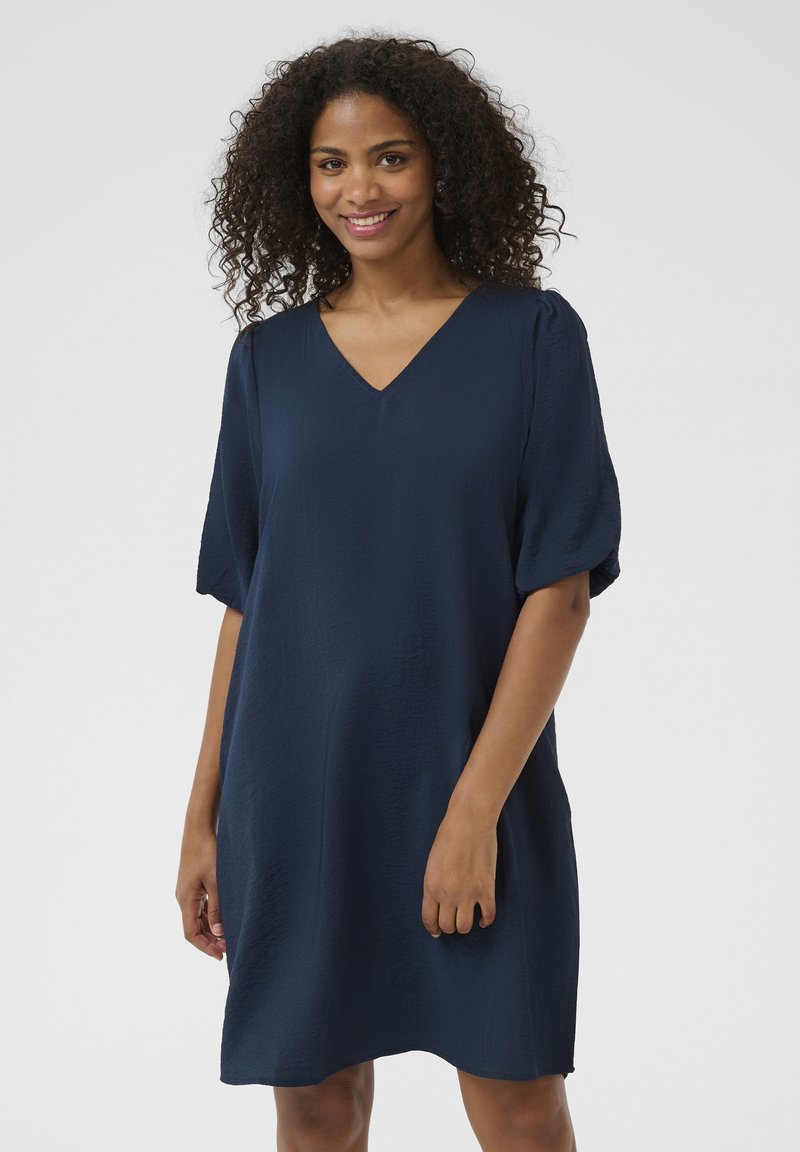 Navy blue dress with V-neckline and short puff sleeves, featuring a textured fabric and an A-line silhouette.