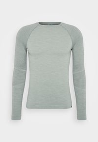 T-shirt térmico de manga longa verde-claro com textura canelada, mangas raglan e acabamentos sem costura nos ombros e braços.
