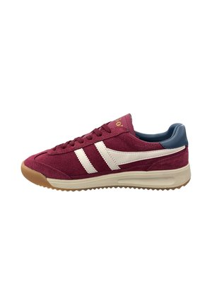 Maroon sneaker with white stripes and a blue heel. Made from suede with a rubber sole featuring a textured pattern for grip.