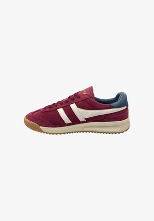 Maroon sneaker with white stripes and a blue heel. Made from suede with a rubber sole featuring a textured pattern for grip.