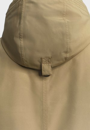 Veste à capuche beige avec une texture lisse, dotée d'une fermeture à boutons et de coutures renforcées le long des seams.
