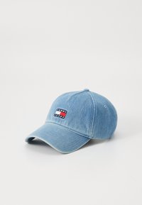 Lyseblå denim baseball cap med en buet skygge, prydet med et rektangulært broderet logo i rød, hvid og blå.