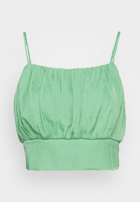 Top cropped verde claro com textura pregueada, alças spaghetti ajustáveis e um acabamento liso. Design simples e justo.