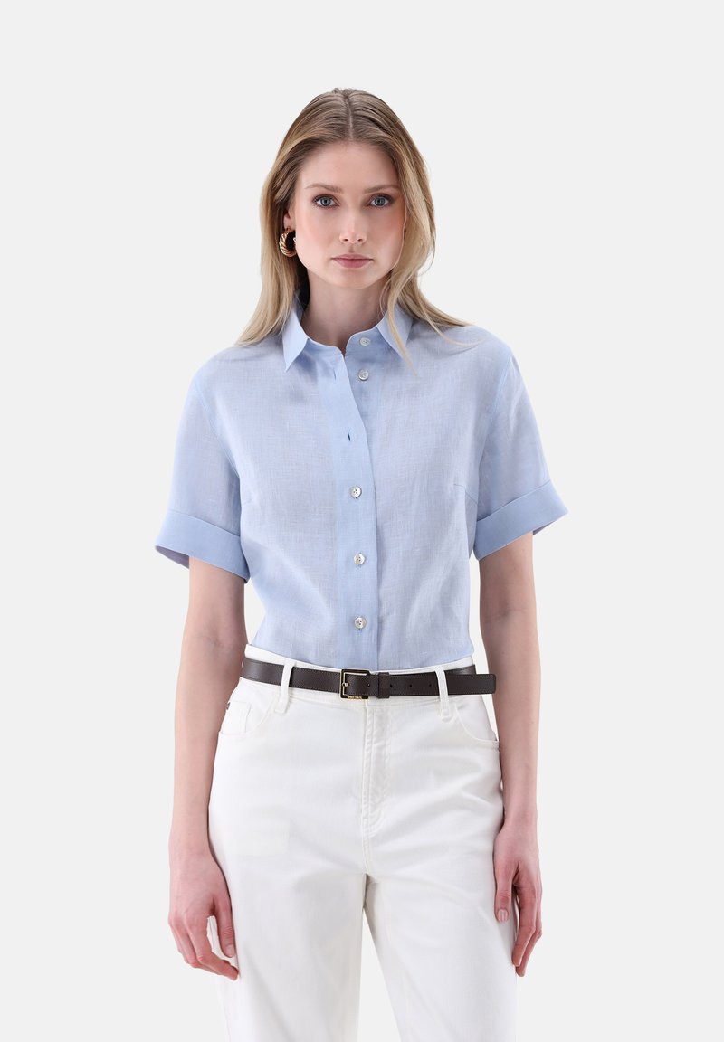 Light blue linen short-sleeve shirt with a button-down front and rolled cuffs, paired with white pants and a brown leather belt.