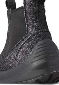 Black ankle boot with a textured, glittery upper, elastic side panels, and a rubber sole featuring a tread pattern for traction.