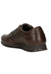Brown leather sneaker featuring a smooth finish, textured side panel, round toe, and rubber sole with small tread for grip.