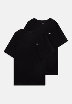 Two black cotton t-shirts with a crew neckline and short sleeves. One features a small embroidered logo on the chest. Soft texture.