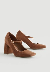 Brown suede high-heeled shoes with a square toe, ankle strap, and chunky heel, featuring a smooth texture and minimalist design.