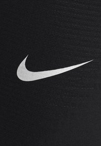 Nike Performance Legginsy do biegania