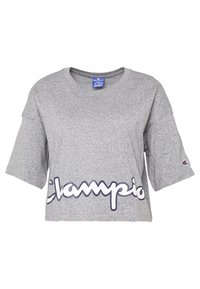 Grå kortärmad t-shirt i slät tyg med en vit "Champion"-logotyp i kursiv stil över framsidan.