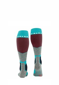 Chaussettes jusqu'au genou en bordeaux, bleu canard, gris et marine, arborant un motif en zigzag et des couleurs contrastées avec le nom de marque « FALKE » en haut.