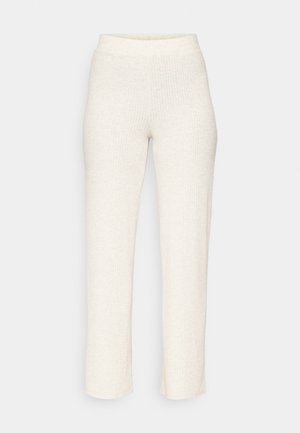 Kreemjas värvuses ribikujulised püksid, millel on figuuri kohandav vöökoht ja sirged jalad, valmistatud pehmest, tekstuuritud kangast. Ilma nähtavate mustrite või aktsendita.