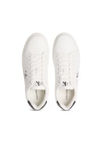White leather sneakers with flat laces, round toe, and black accent at the heel; features a logo on the side and padded interior.
