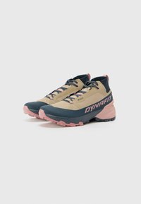 Trail running shoes in beige, navy, and pink. Features a textured upper, sturdy laces, and a pronounced rubber sole for grip.