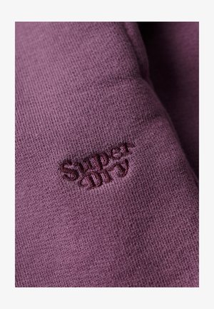 Purple cotton fabric with a ribbed texture, featuring an embroidered "Superdry" logo in a slightly darker shade.