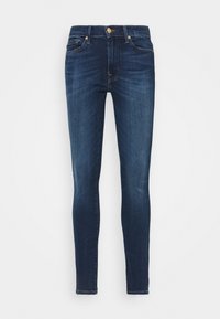 Mörkblå skinny jeans med en jämn textur, fem fickor och hårdvara i gyllene ton vid midjan och dragkedjan.