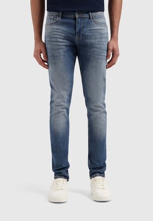 Donkerblauwe denim jeans met een vervaagde wassing, slim fit, vijf-pocket ontwerp, koperen knoopsluiting en witte stiksels.