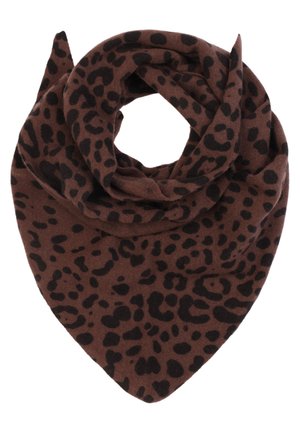 Woman with blonde hair wearing a large brown leopard-print scarf over a black buttoned shirt dress, against a plain light background.
