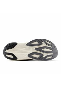 Shoe sole featuring a wavy design, predominantly gray with white accents. Textured rubber for grip, with various cutouts for flexibility.