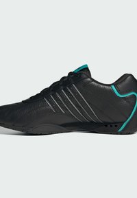 Black athletic shoe featuring a smooth leather upper, three silver stripes, and turquoise accents at the heel and tongue. Lightweight design.