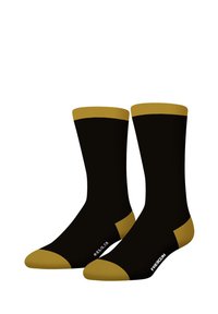 Chaussettes noires avec des accents dorés en haut et sur les orteils. Le design présente une texture lisse et un logo imprimé près de la cheville.