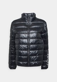 Black puffer jacket with a high collar, featuring horizontal quilted sections, a center zip closure, and text accent on the left sleeve.