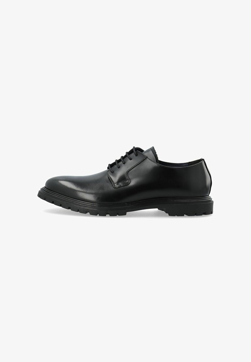 Zwarte leren oxford schoen met een ronde neus, lage hoogte en vetersluiting. Voorzien van een gestructureerde zool voor betere grip.
