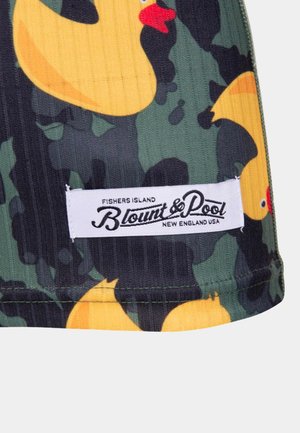 Green camouflage fabric featuring yellow rubber duck patterns. Includes a white label with "Blount & Pool" branding at the bottom.