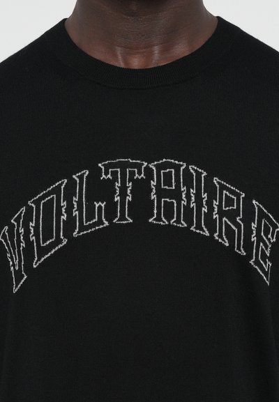 Black sweater with a round neckline featuring white embroidered text "VOLTAIRE" in a bold, stylized font across the chest.
