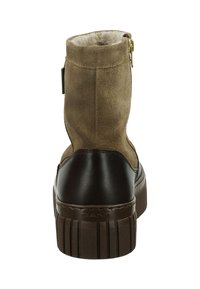 Brown suede ankle boot with a smooth leather heel, zip closure, textured sole, and soft lining visible at the top opening.