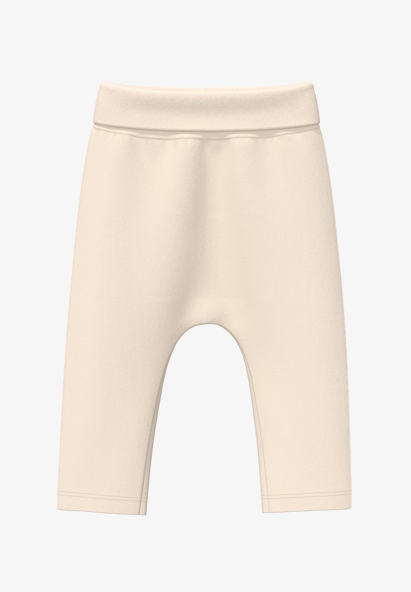 Beige katoenen blend leggings met een zachte textuur, elastische tailleband en een knielange pasvorm. Er zijn geen patronen of extra hardware aanwezig.