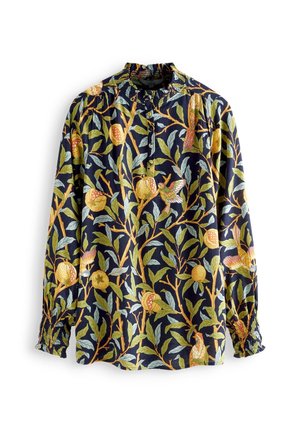 Navy blouse with long sleeves, smocked collar and cuffs, featuring yellow pomegranates, green leaves, and multicolored hummingbird prints.