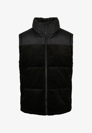 Gilet matelassé noir avec col haut. La moitié supérieure est en tissu lisse, la moitié inférieure présente une texture côtelée. Fermeture éclair à l'avant et poches latérales.