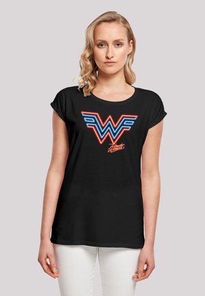 Black t-shirt with rolled sleeves, featuring a neon blue and red "WW" logo and text "Wonder Woman" in a cursive font on the front.